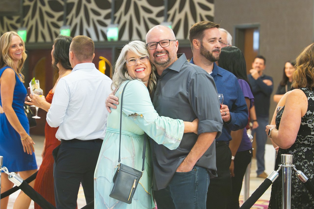 A Renown couple hugging and smiling in the lobby
