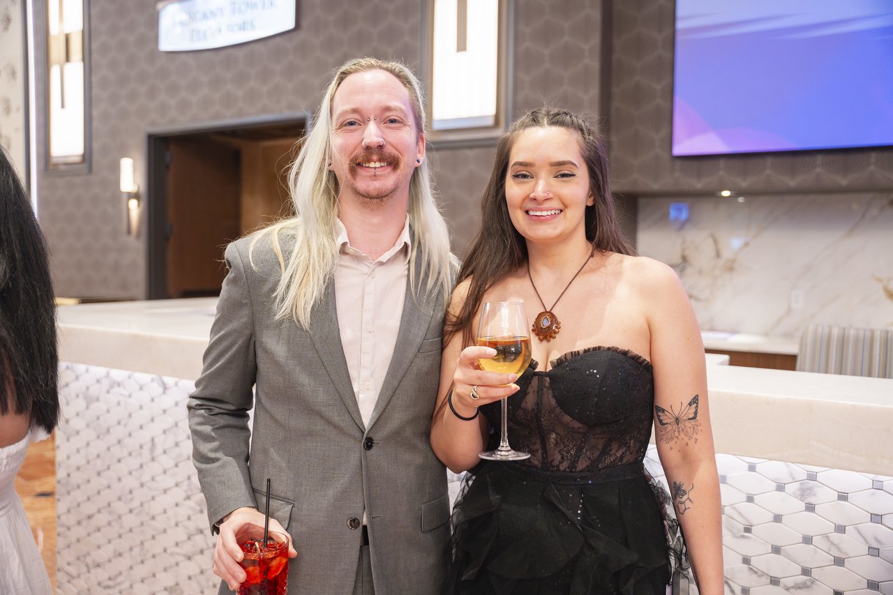 A Renown couple smiling together in the lobby before dinner