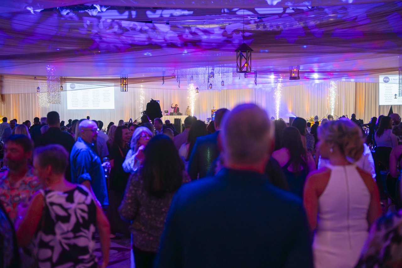 The Renown crowd facing the stage under purple lights