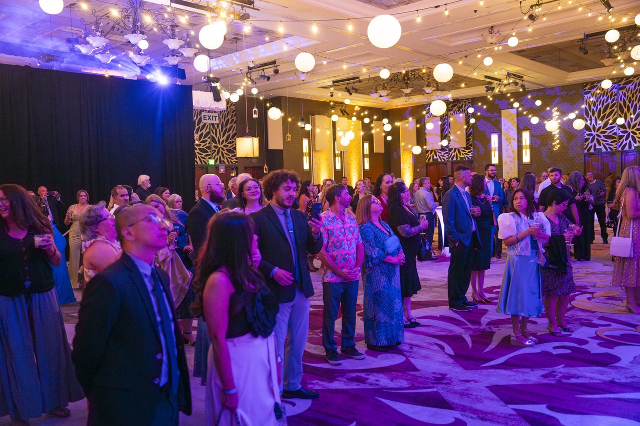 The Renown crowd gathering on the dance floor under string lights