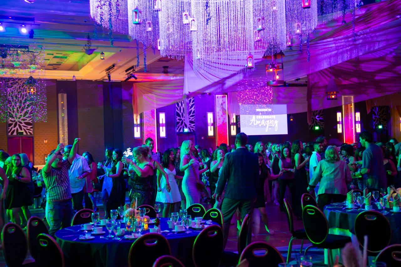 The Renown dance floor packed under green lights and the crystal chandelier