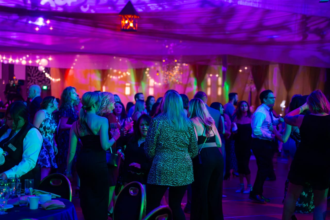 Renown guests filling the dance floor under purple and pink lights