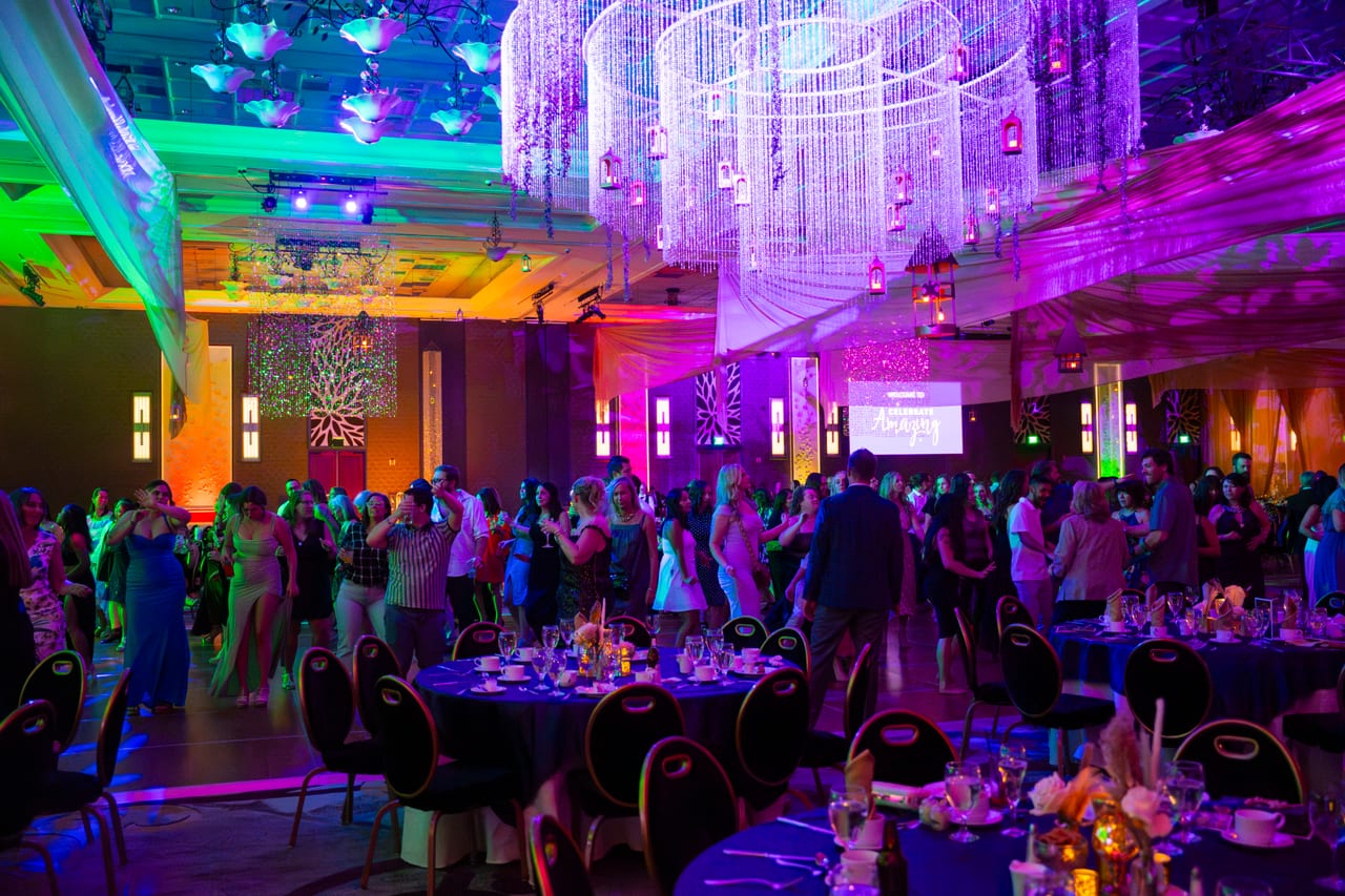 The dance floor packed with Renown guests under the crystal chandeliers