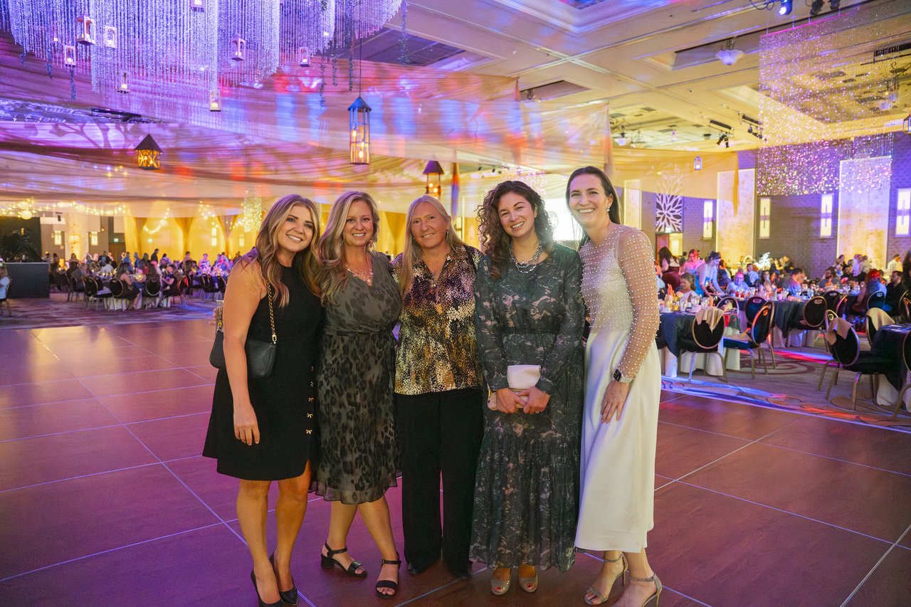 Five Renown friends posing together on the dance floor