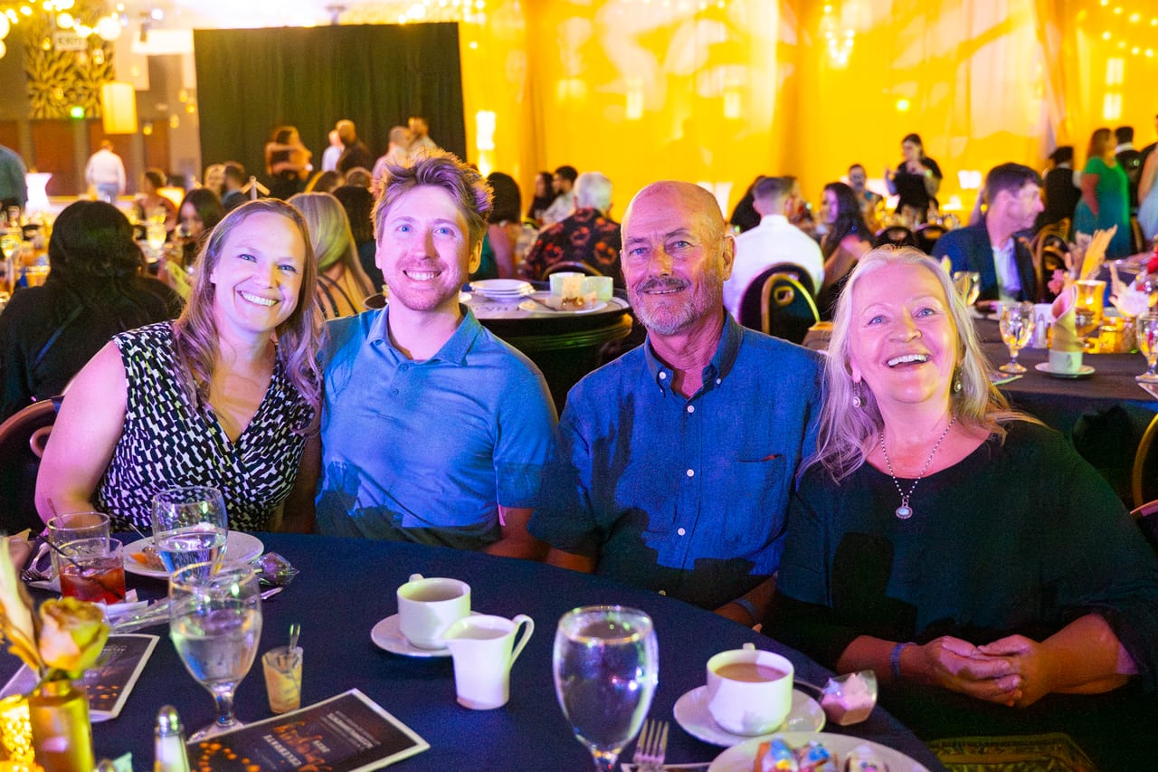 Four Renown coworkers laughing together at their table