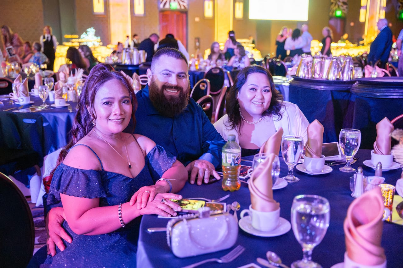Three Renown friends smiling at their table during dinner