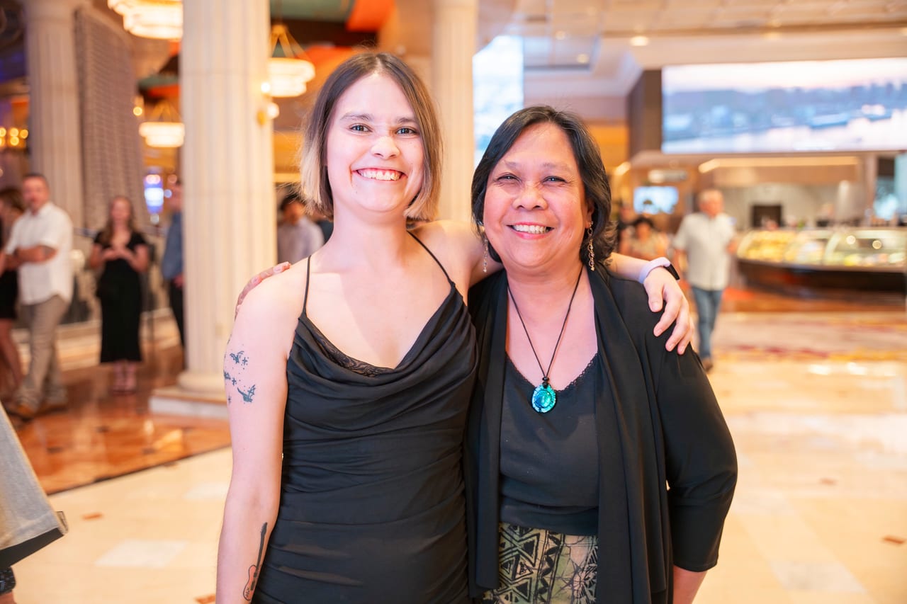 Two Renown friends arm in arm in the Peppermill lobby