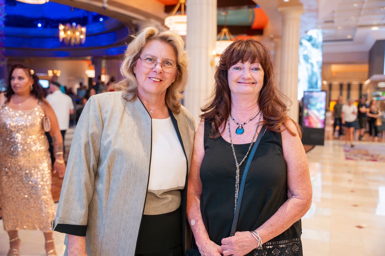 Two Renown friends posing in the Peppermill lobby on the way in