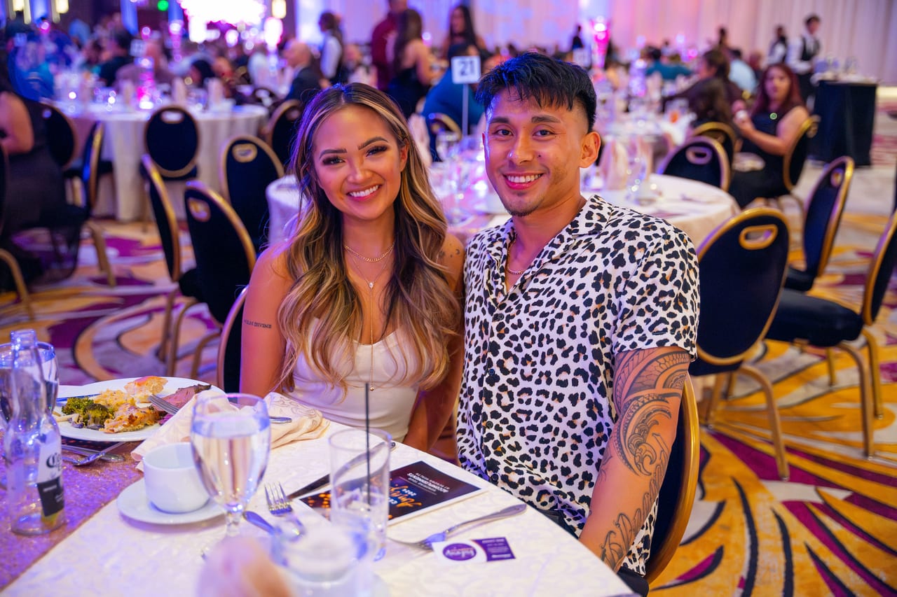 Two Renown friends smiling at their table during dinner