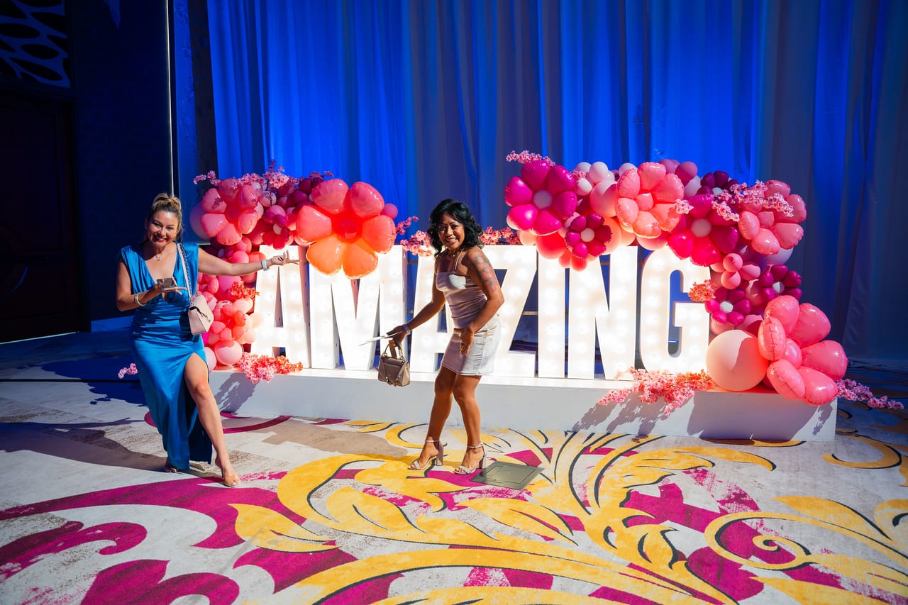 Two Renown friends striking a pose at the AMAZING letters