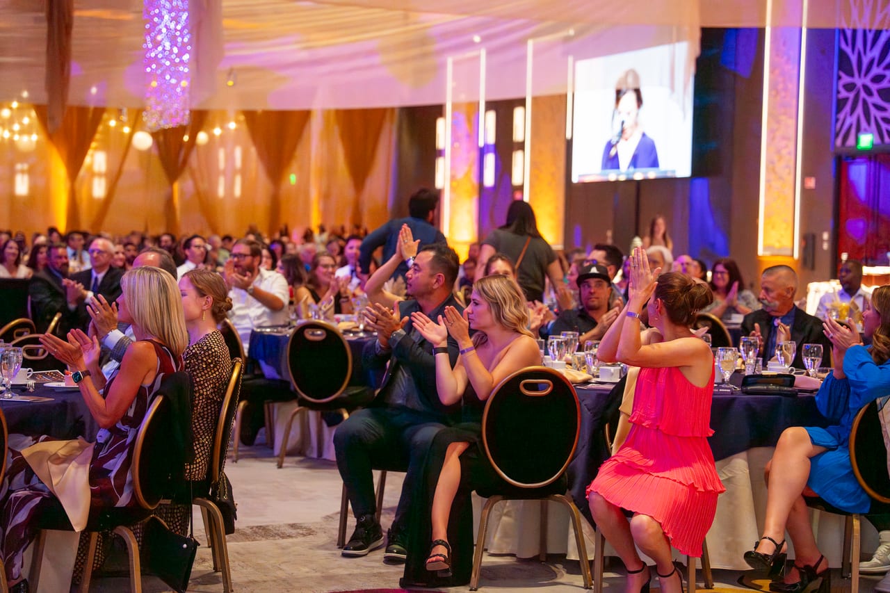 Renown guests applauding from their tables during the program