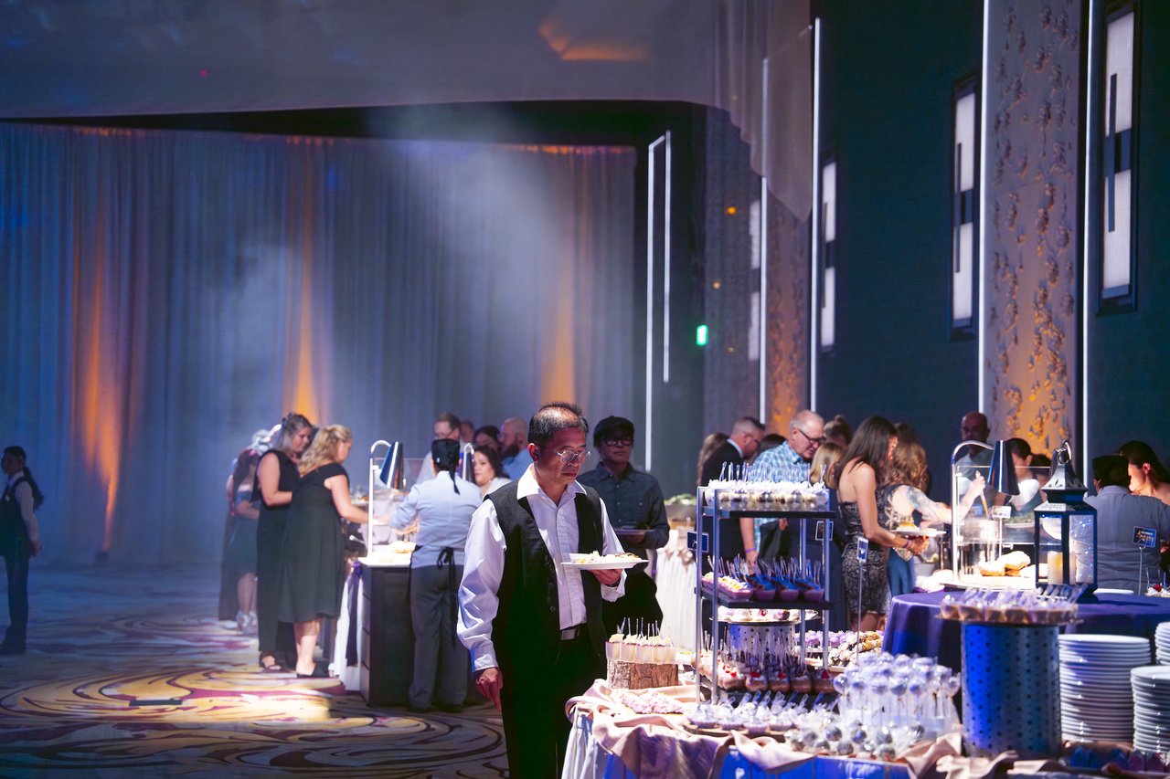Renown guests filling their plates at the dessert buffet