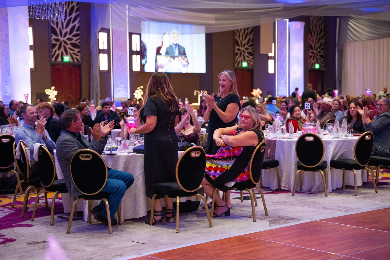 Renown guests on their feet cheering as a coworker is called up