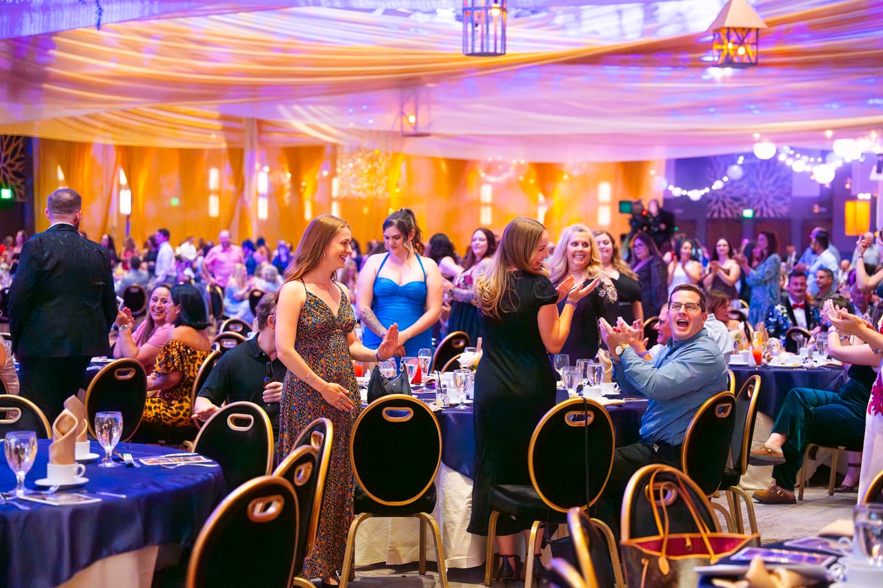 Renown guests cheering and clapping as an honoree heads to the stage