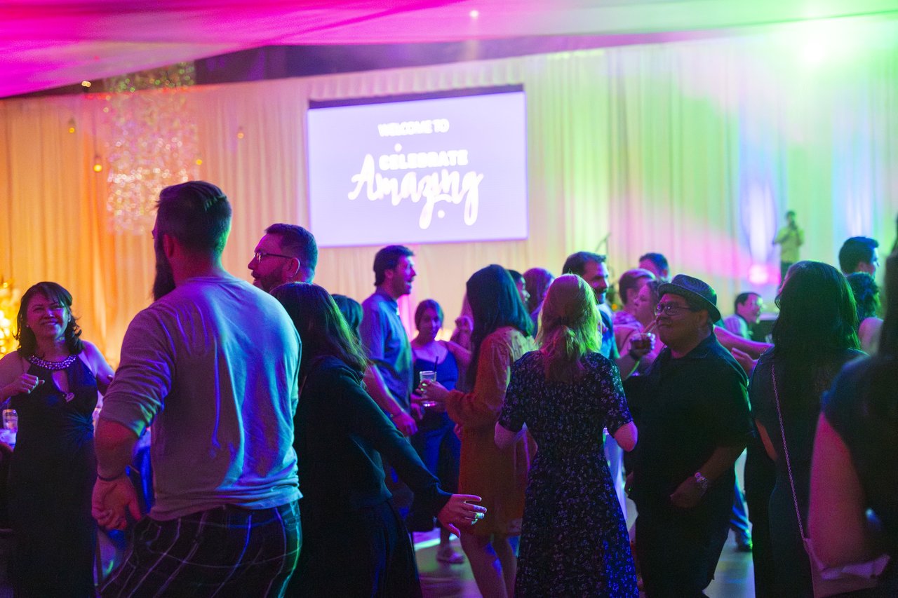 Renown guests dancing under the Celebrate Amazing welcome screen