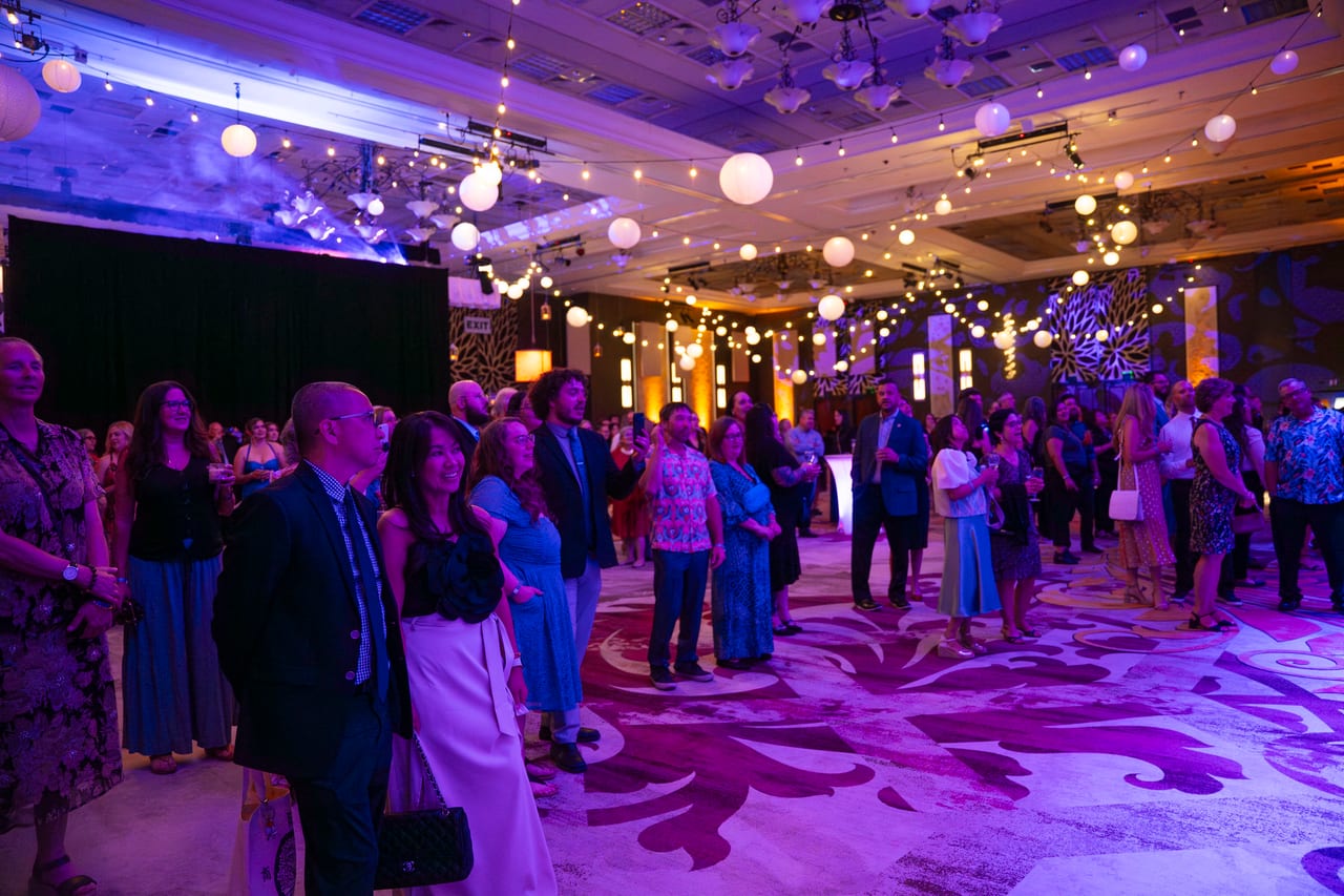 Renown guests gathering under the string lights as the night begins