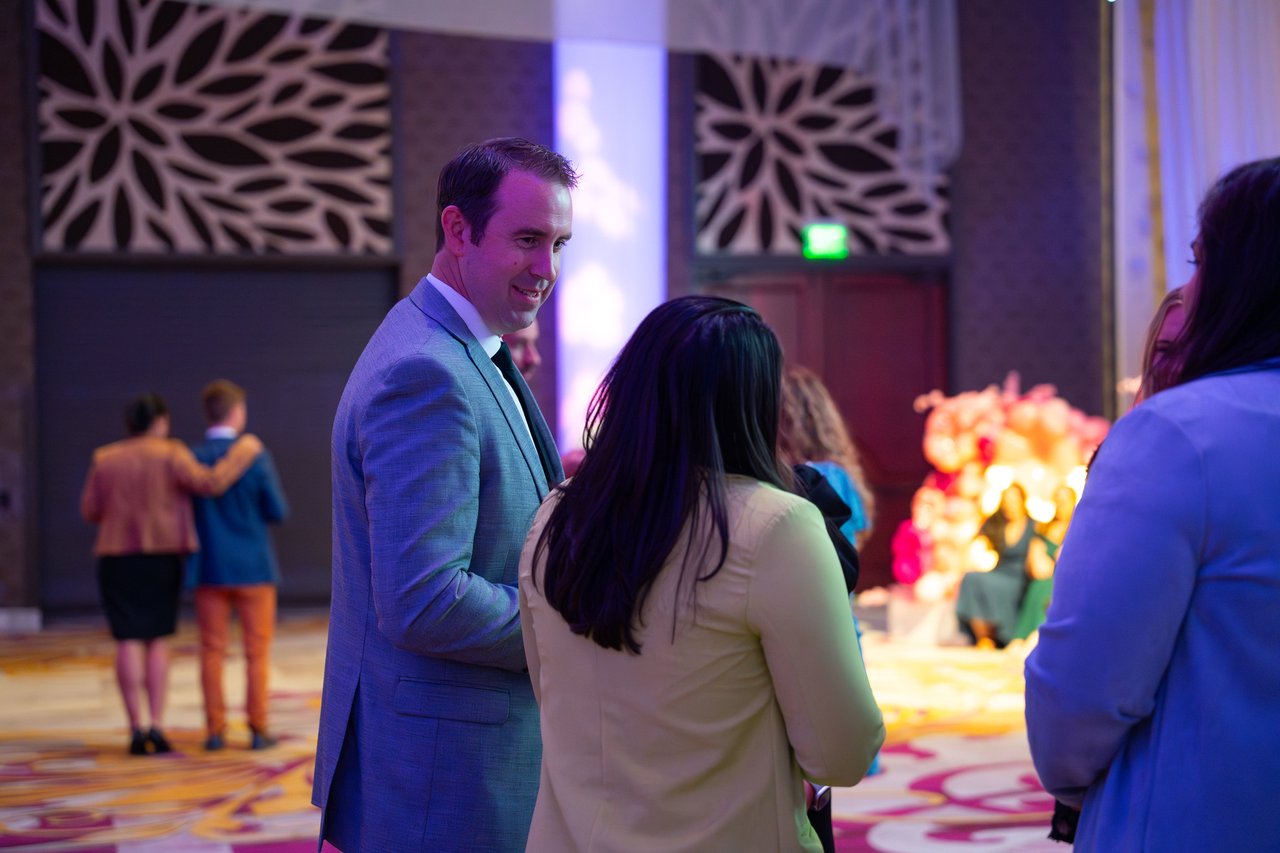 Renown guests greeting each other near the balloon flowers