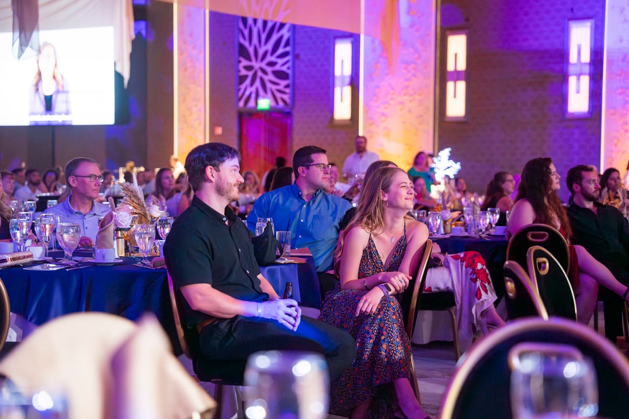 Renown guests laughing at their tables during the program