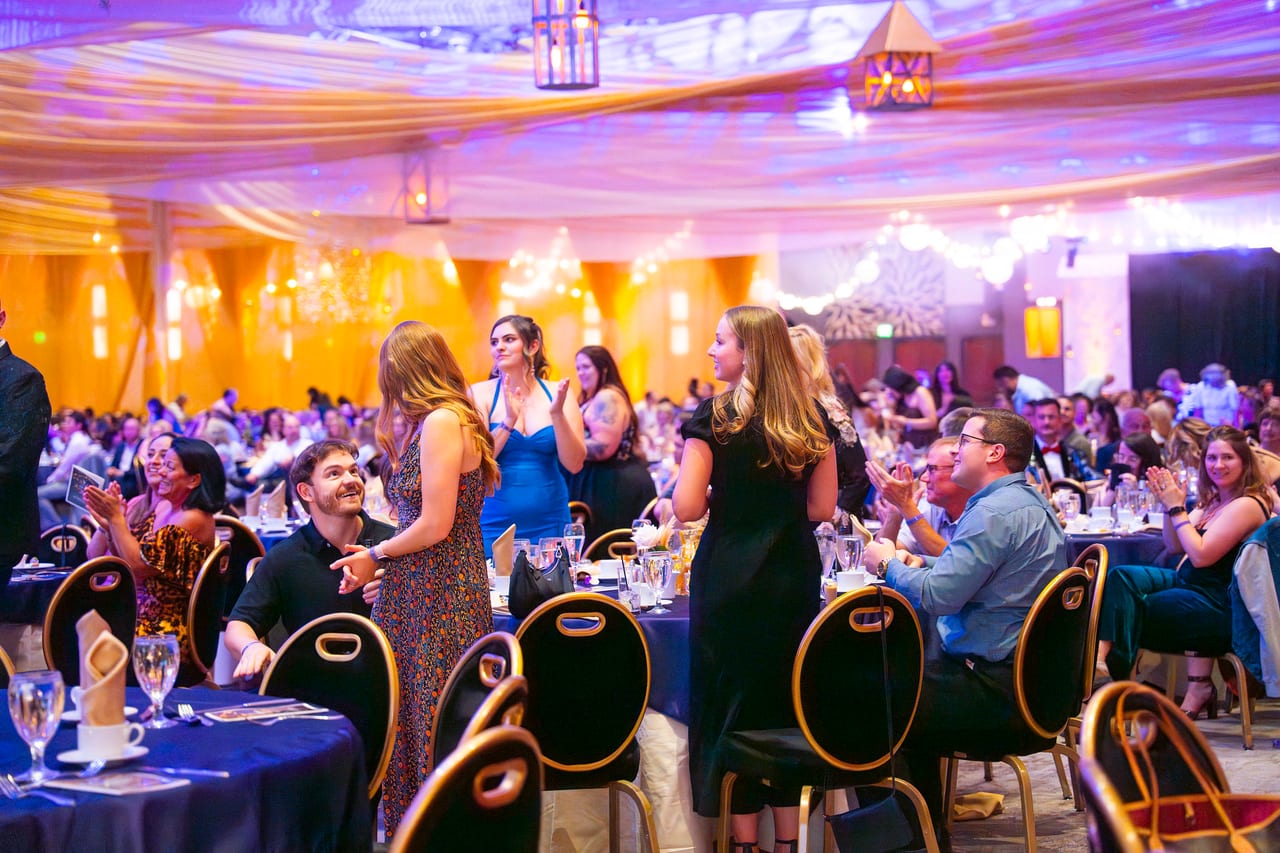 Renown guests standing up to applaud from their tables