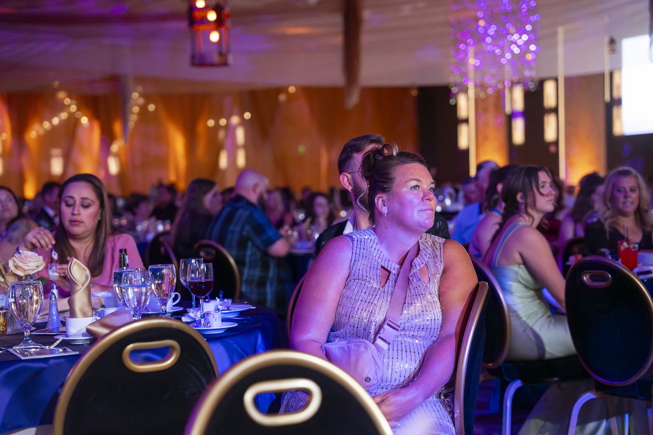 Renown guests watching the stage from their tables