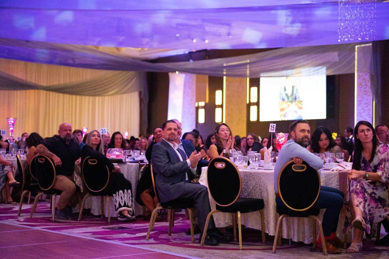 Renown guests at their tables watching the program on the big screens