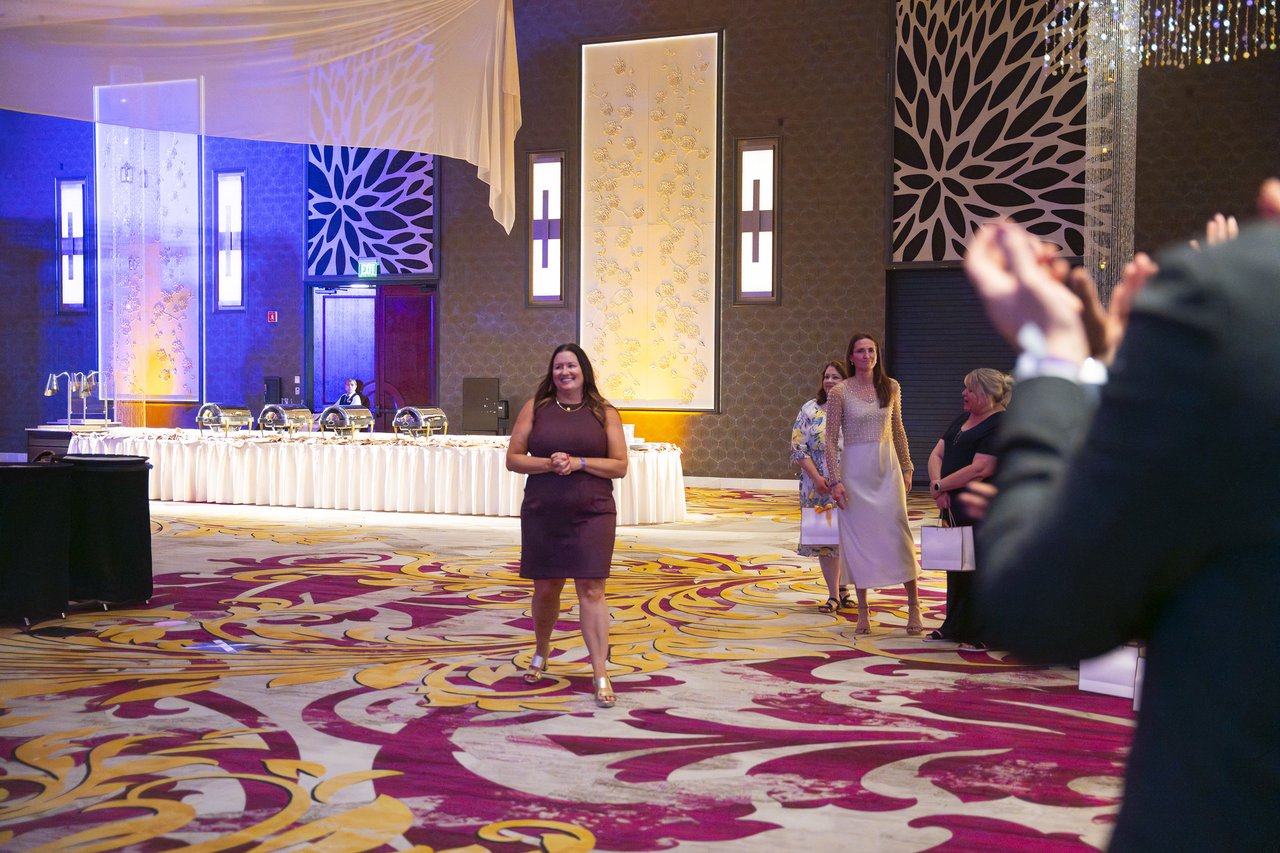 A Renown honoree walking up to the stage as the room applauds