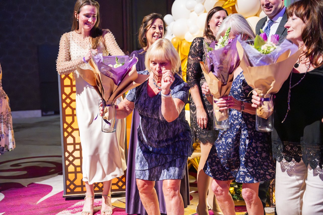 A Renown honoree overcome with joy as she receives her bouquet