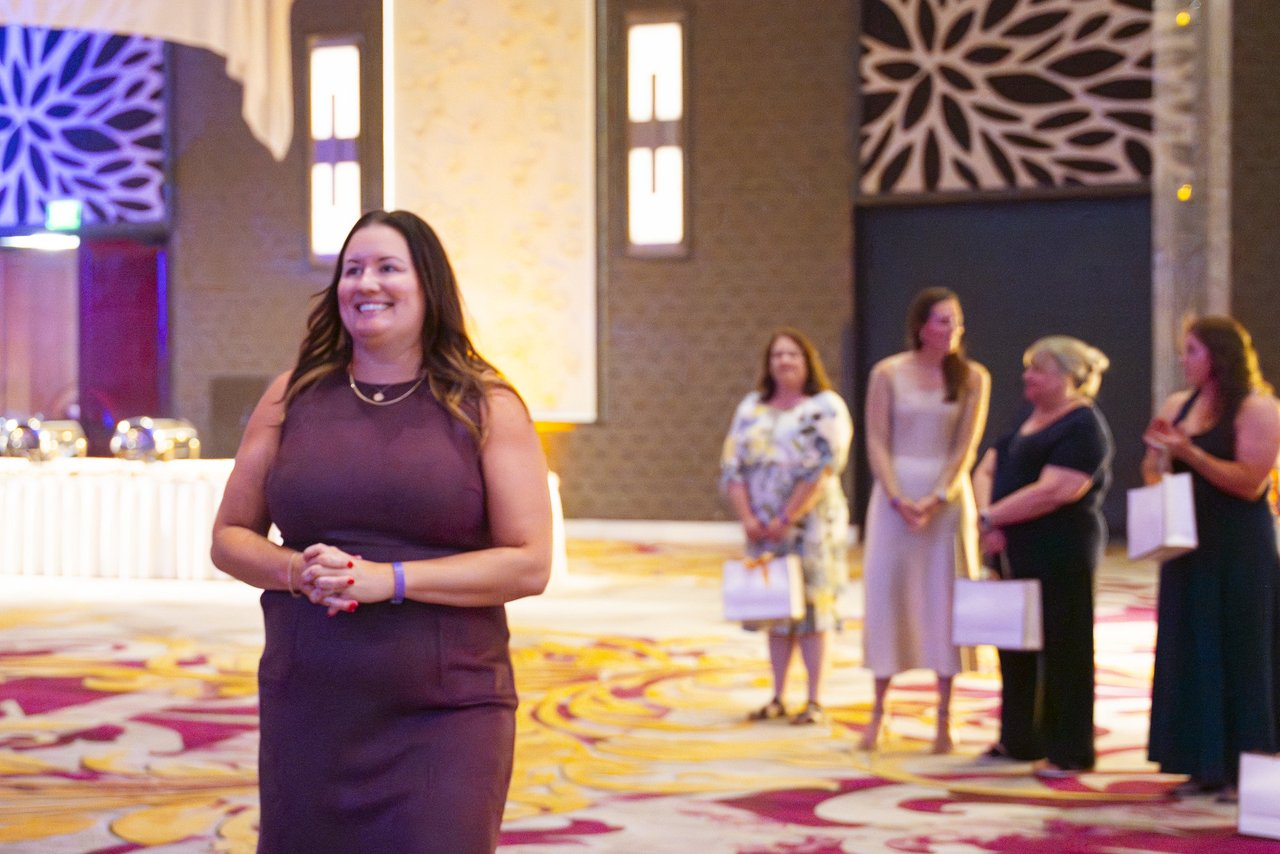 A Renown honoree smiling as she waits her turn on the dance floor
