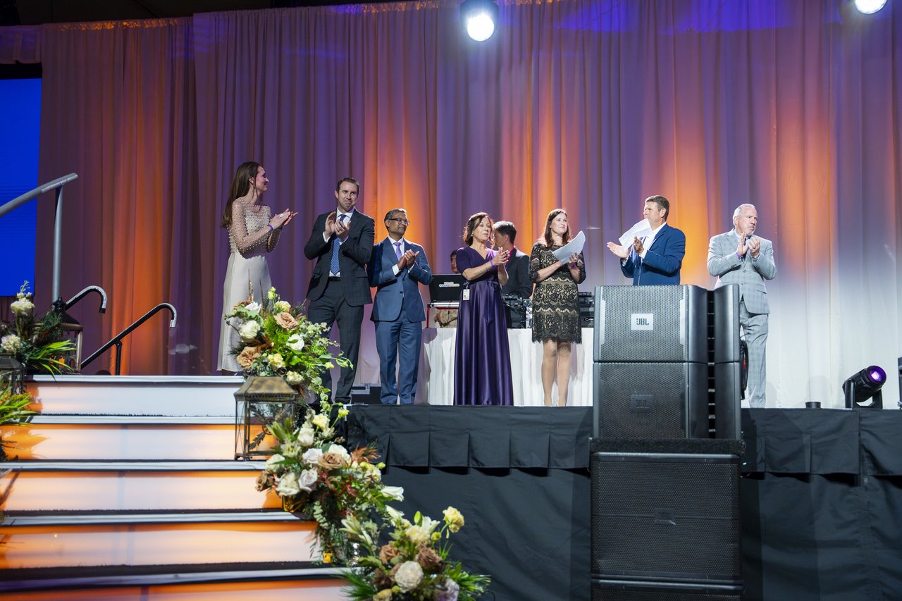 Renown honorees and leaders applauding together on stage