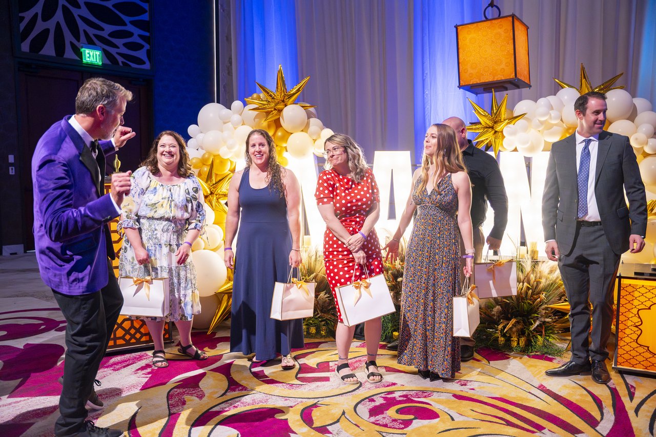 Renown honorees with their gift bags at the gold balloon arch