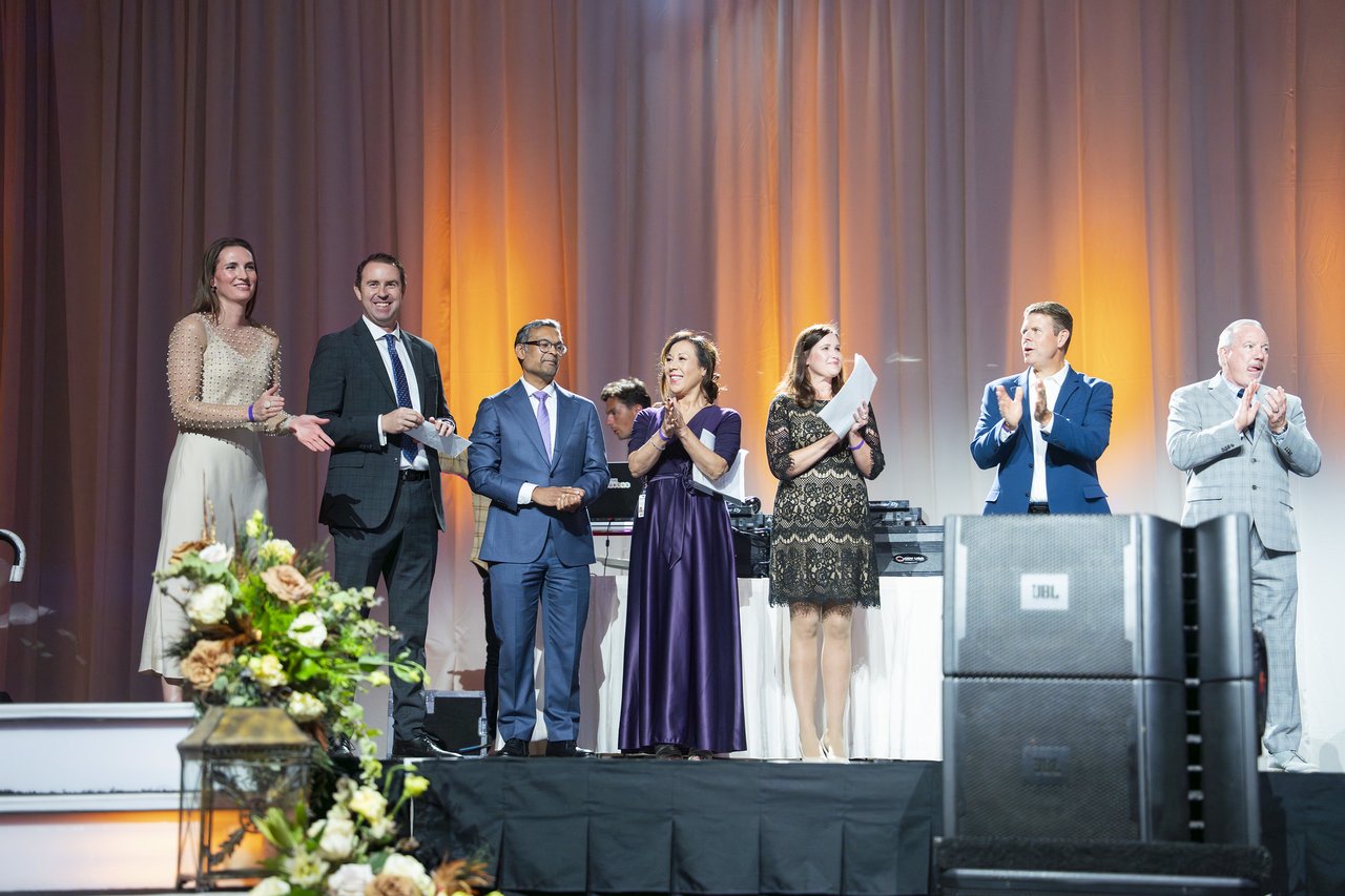 Renown honorees and leaders clapping together on stage
