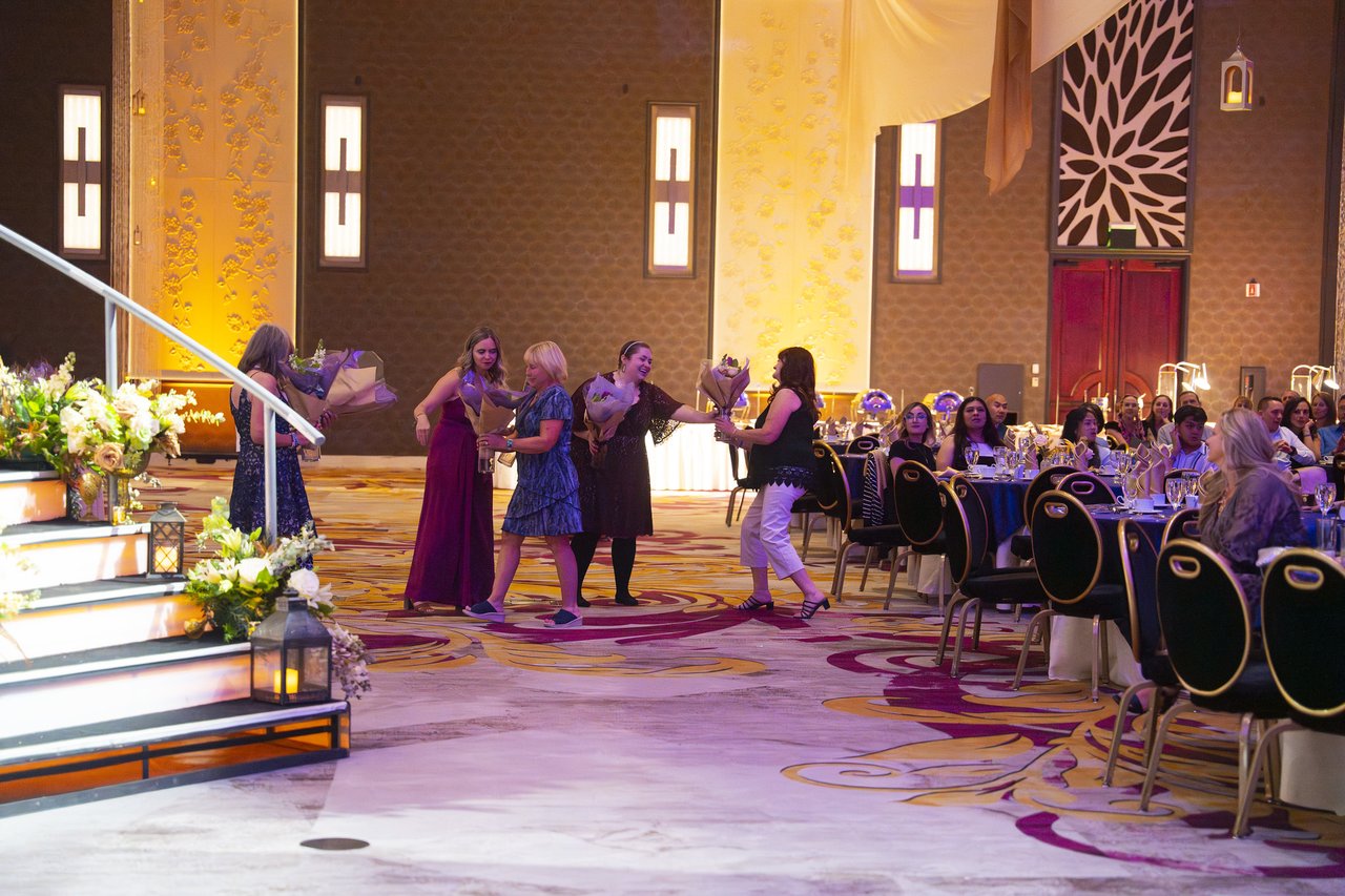 Renown honorees crossing the ballroom toward the stage