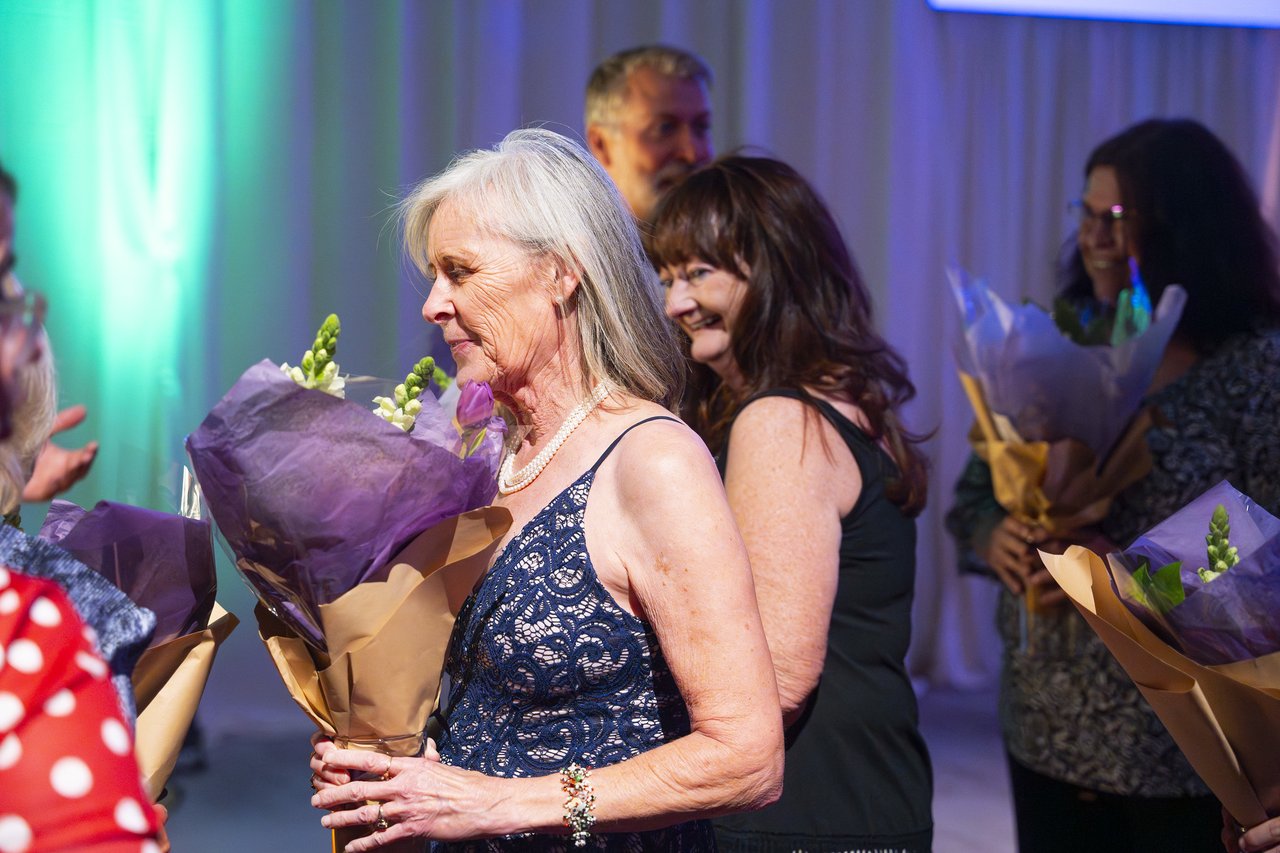 Renown honorees holding their bouquets backstage before the walk