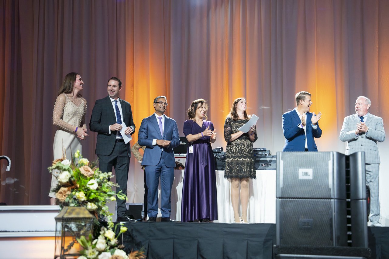 Renown honorees lined up on stage behind the flowers