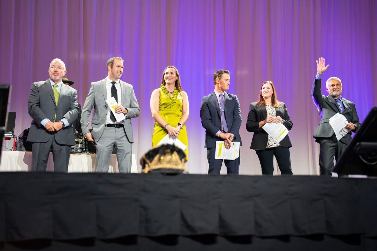 Renown honorees lined up on stage holding their programs