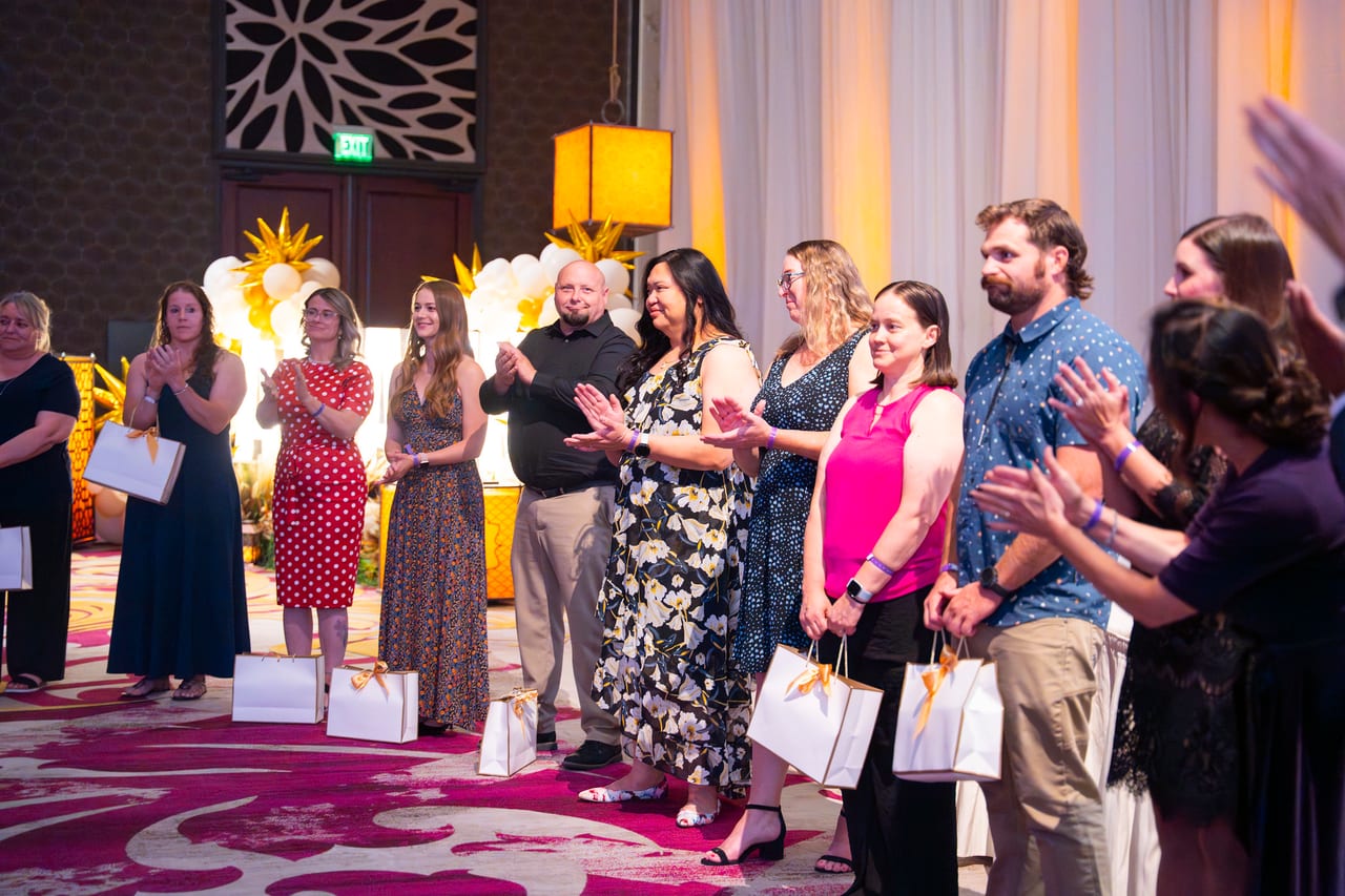 Renown honorees lined up with their gift bags as the room applauds