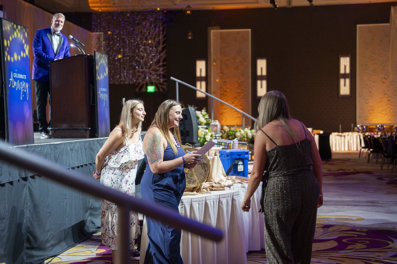 Renown honorees reading their cards by the stage