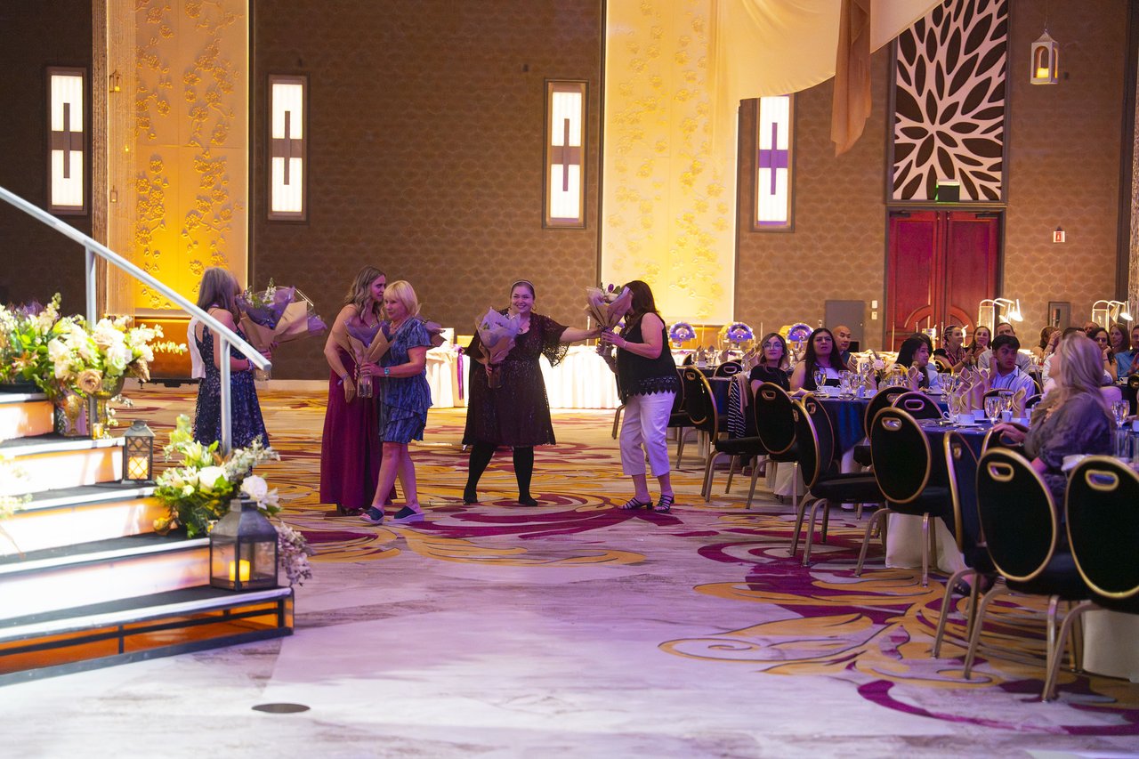 Renown honorees walking back to their tables with their bouquets