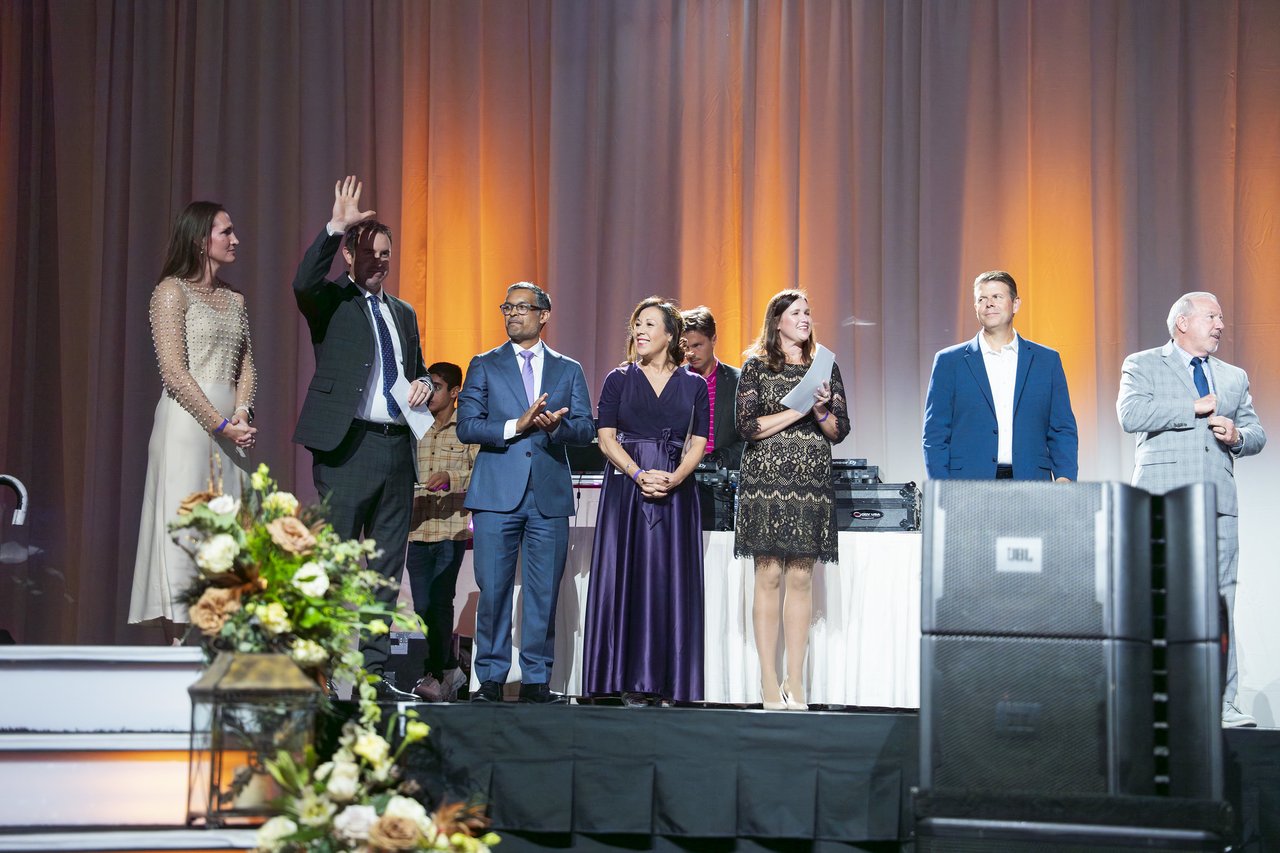 Renown honorees waving to the room from the stage