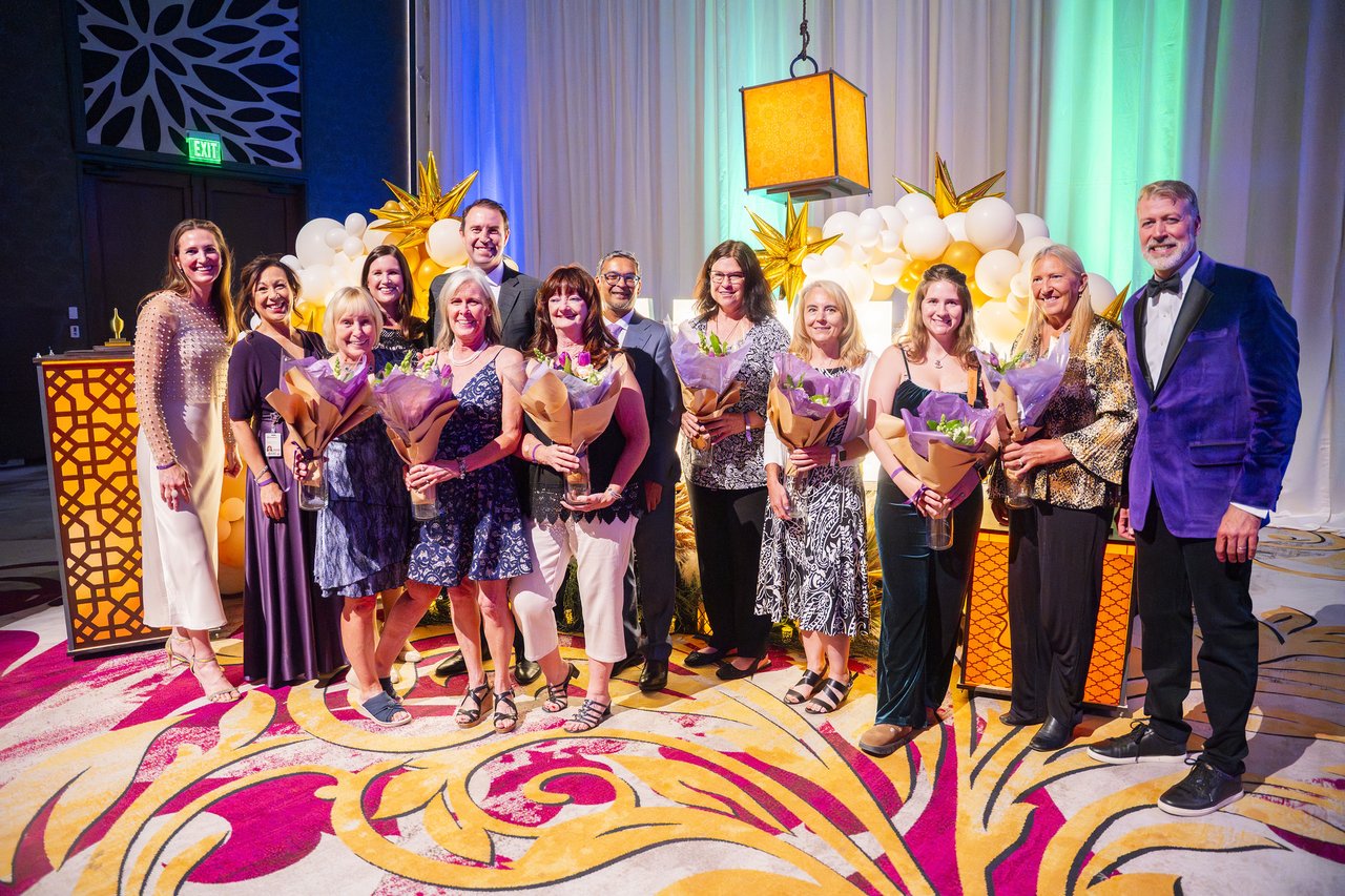 Renown honorees holding their bouquets beside the host