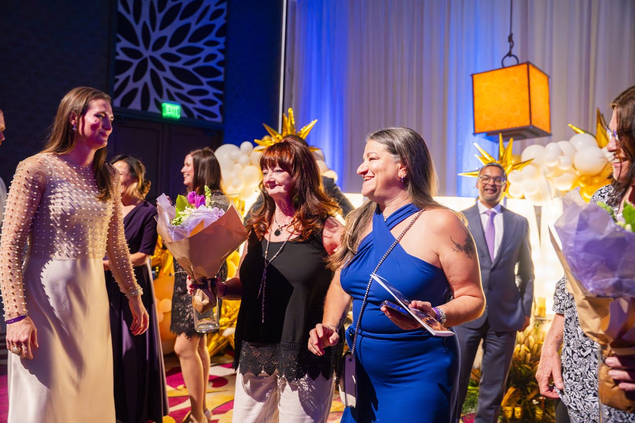 Renown honorees with their bouquets at the gold balloon arch