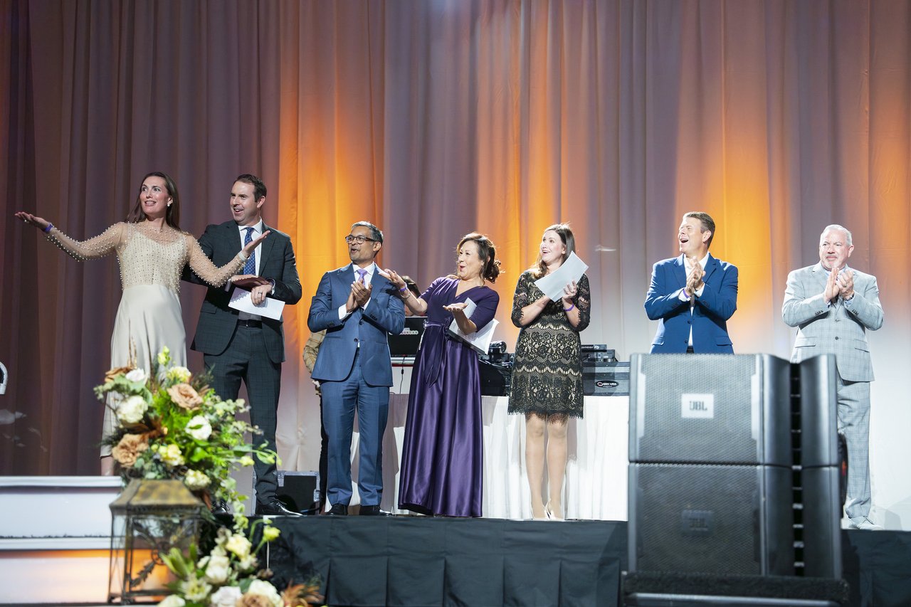 The host introducing the Renown leaders on stage