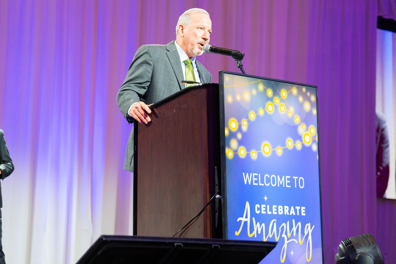 A Renown leader speaking at the Celebrate Amazing podium