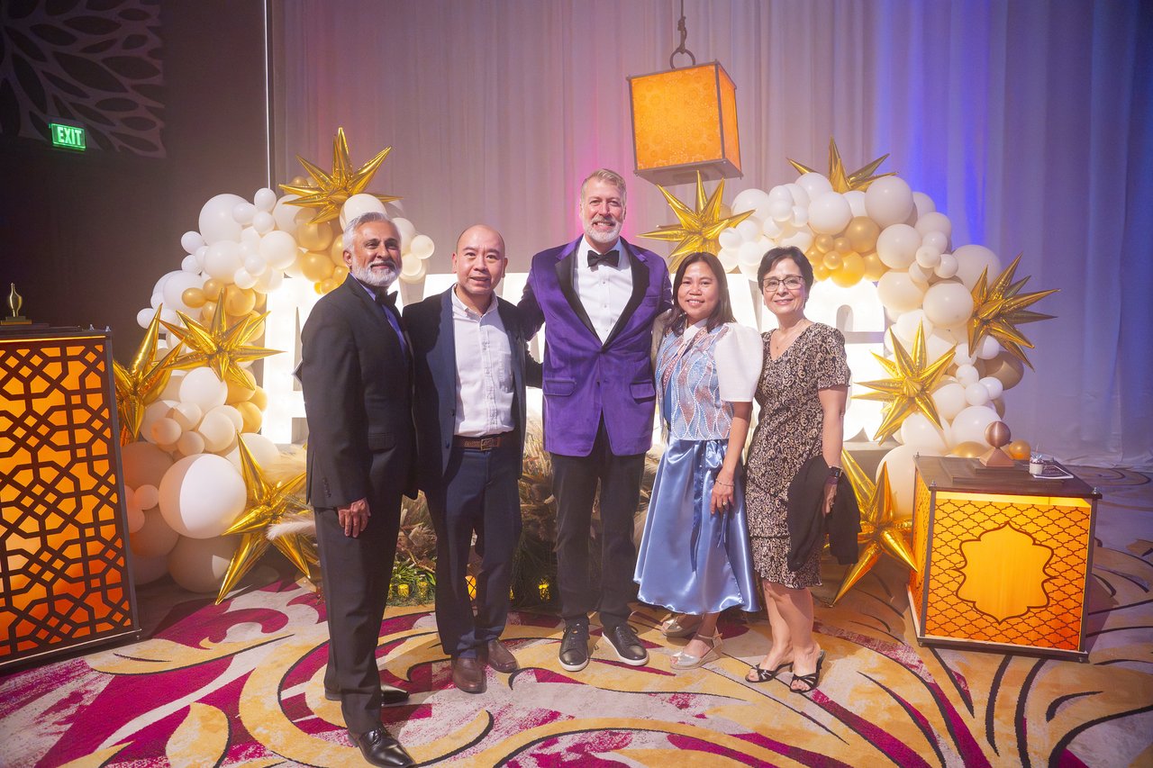 Renown leaders and guests posing at the balloon arch