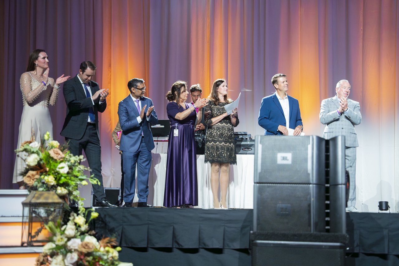 Renown leaders applauding the honorees from the stage
