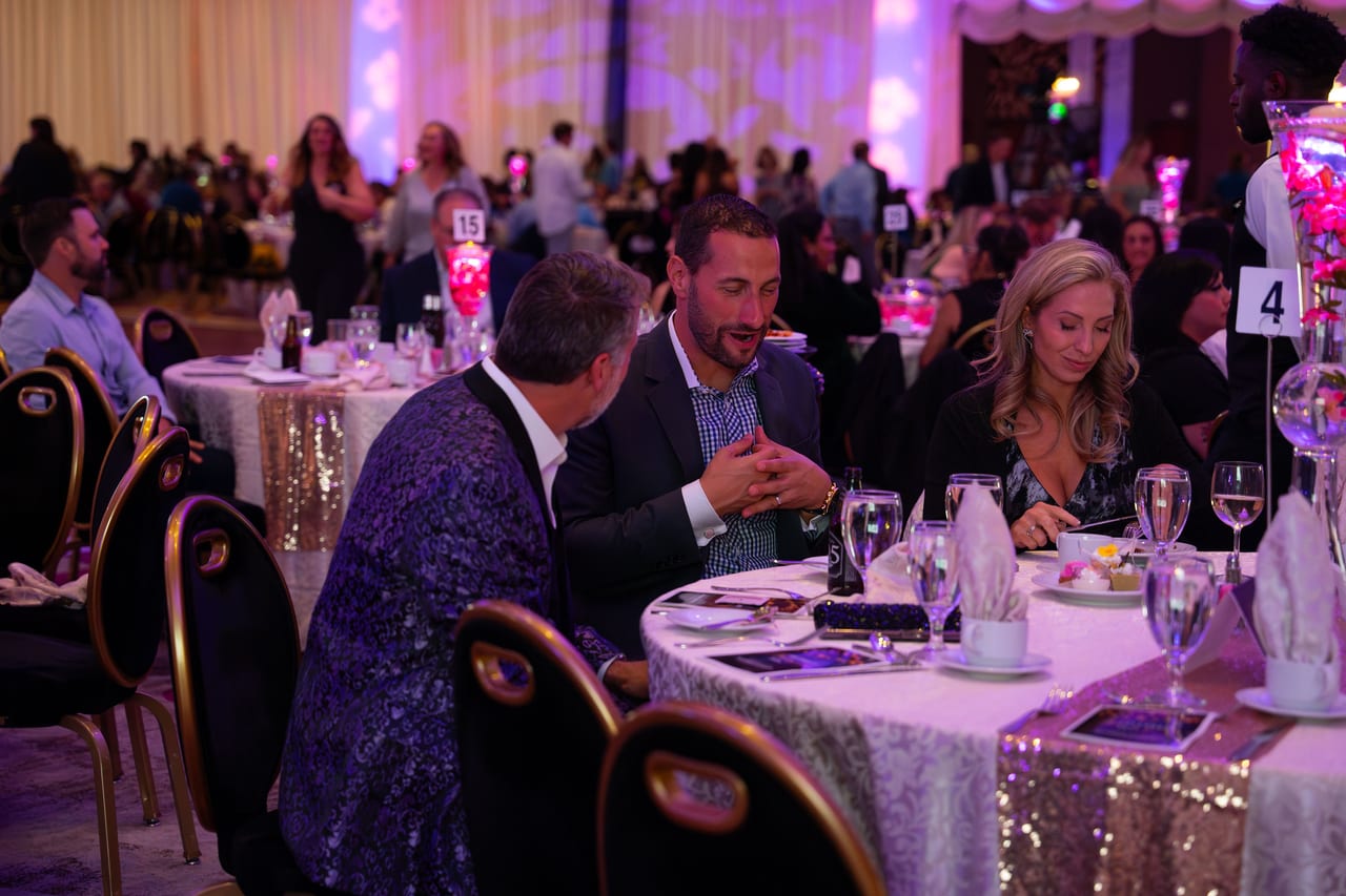 Renown leaders talking at their table during dinner