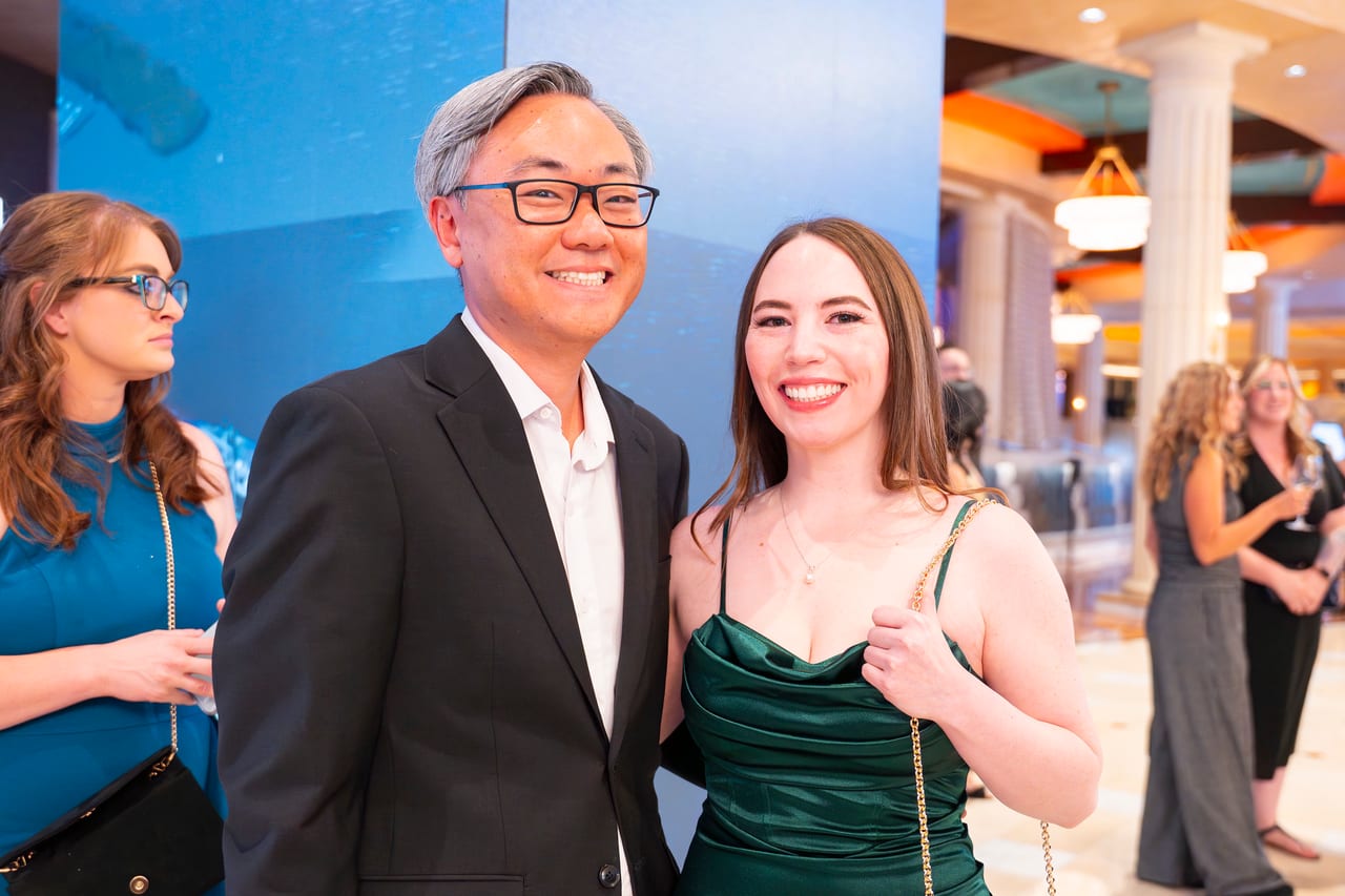 Two Renown guests smiling in the lobby by the Peppermill columns