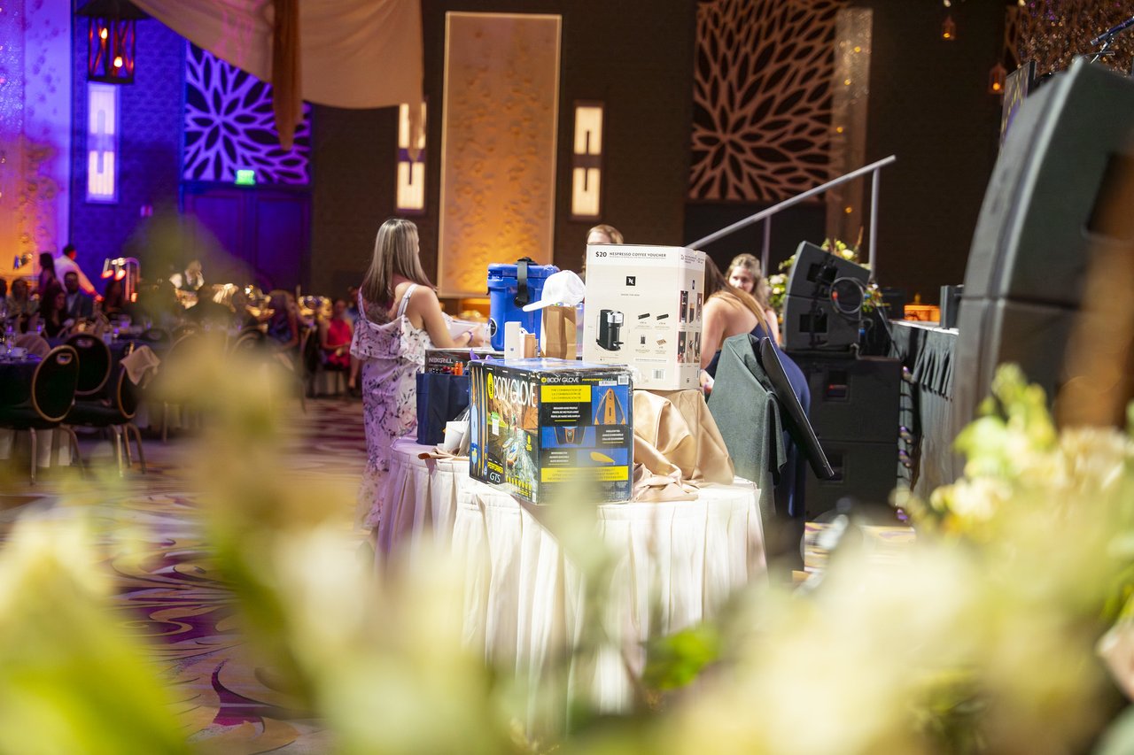 The raffle prizes seen through the table flowers