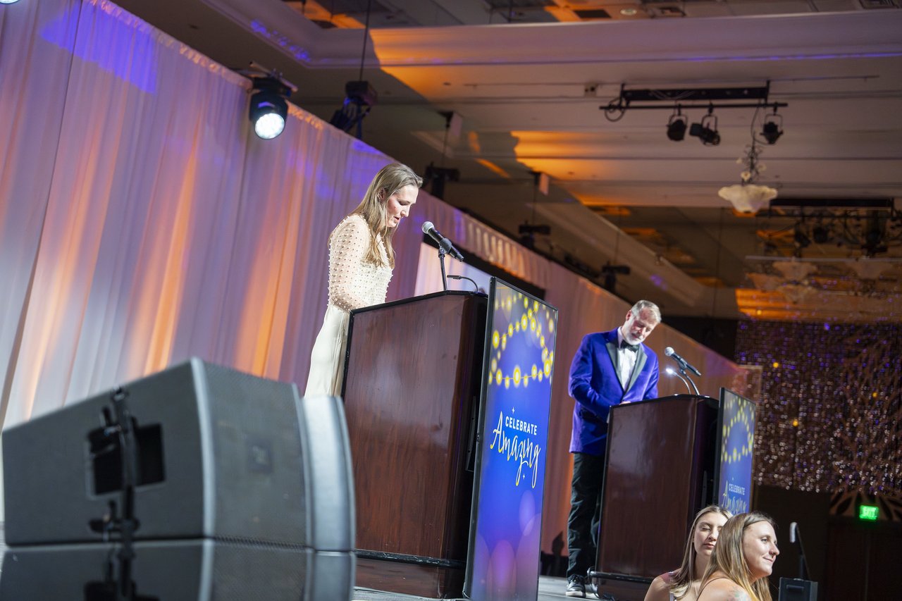 A Renown leader and the host speaking from the two podiums