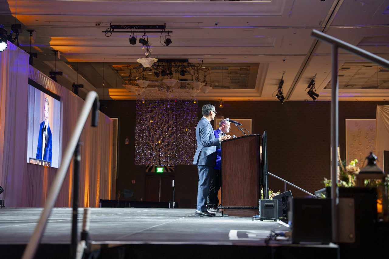 A Renown leader speaking on the stage seen from below
